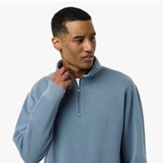 Model wearing Independent Trading Co PRM4600QZ Unisex Pigment-Dyed Quarter-Zip Pullover Sweatshirt
