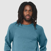 Model wearing Bella Canvas 3901 Sponge Fleece Raglan Crewneck Sweatshirt